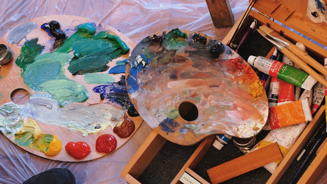 Artist organizing paints and materials in a well-designed studio space